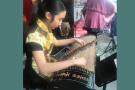 a young girl playing a musical instrument